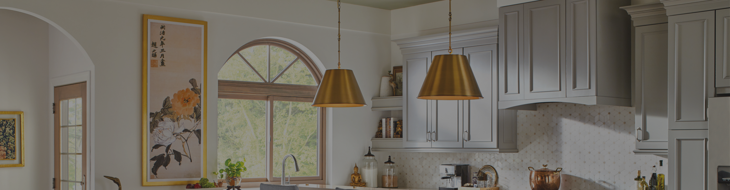 Modern kitchen with brass pendant  lights and white and yellow tile backsplash.